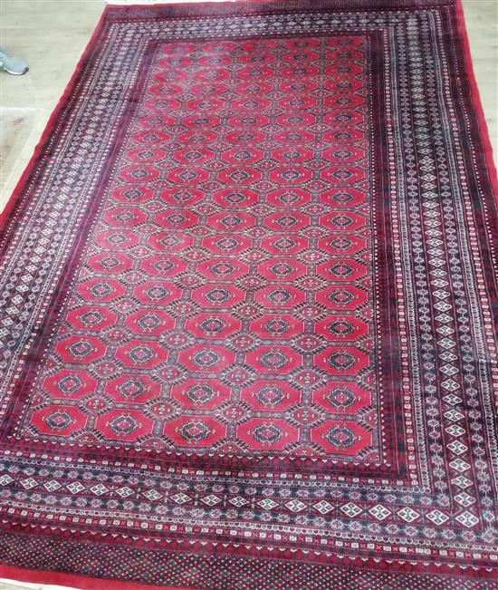 A Pakistan Bokhara red ground rug 310 x 215cm